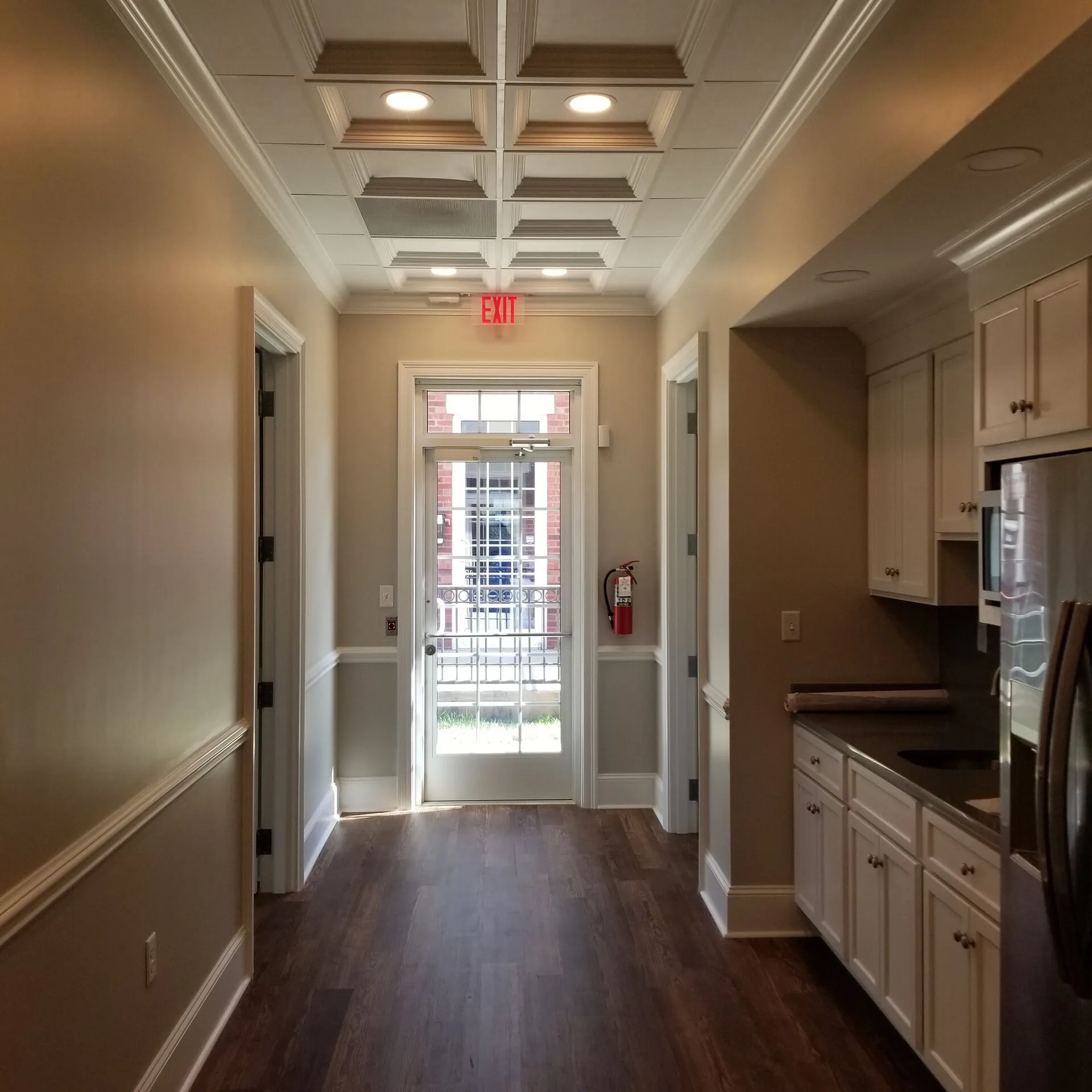 Room with coffered ceiling detail and crown molding