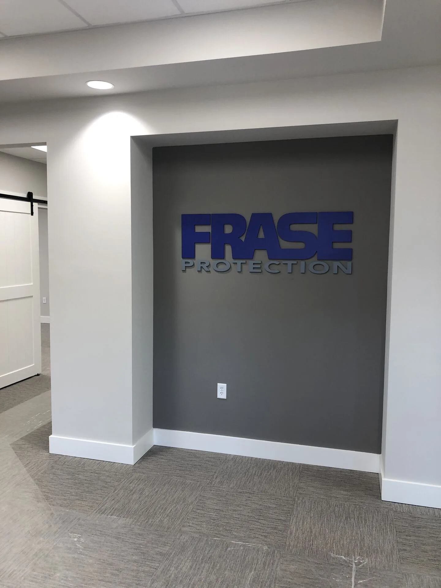 Frase Protection branded reception signage in entry vestibule