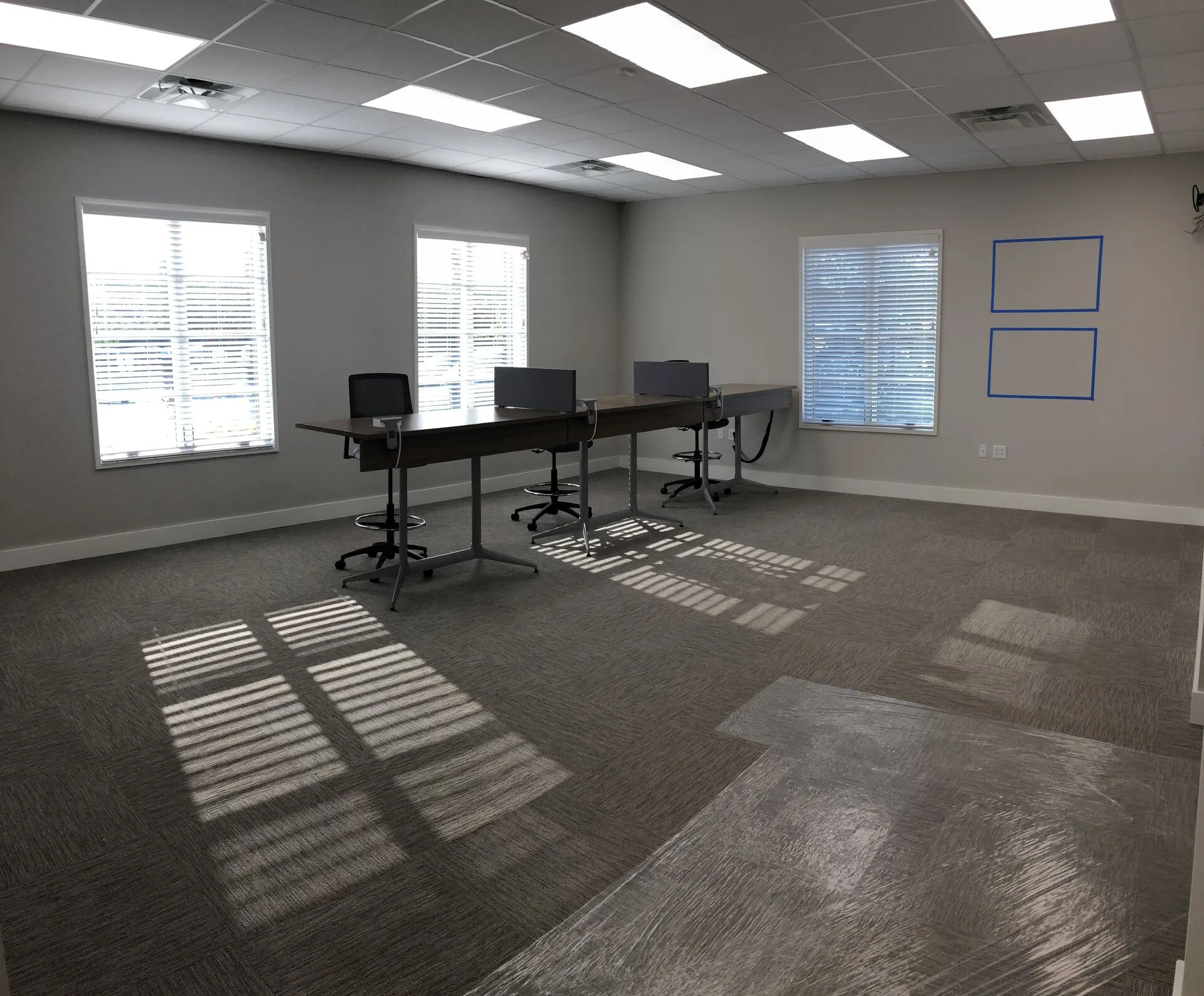 Open sales floor with three workstations and natural light
