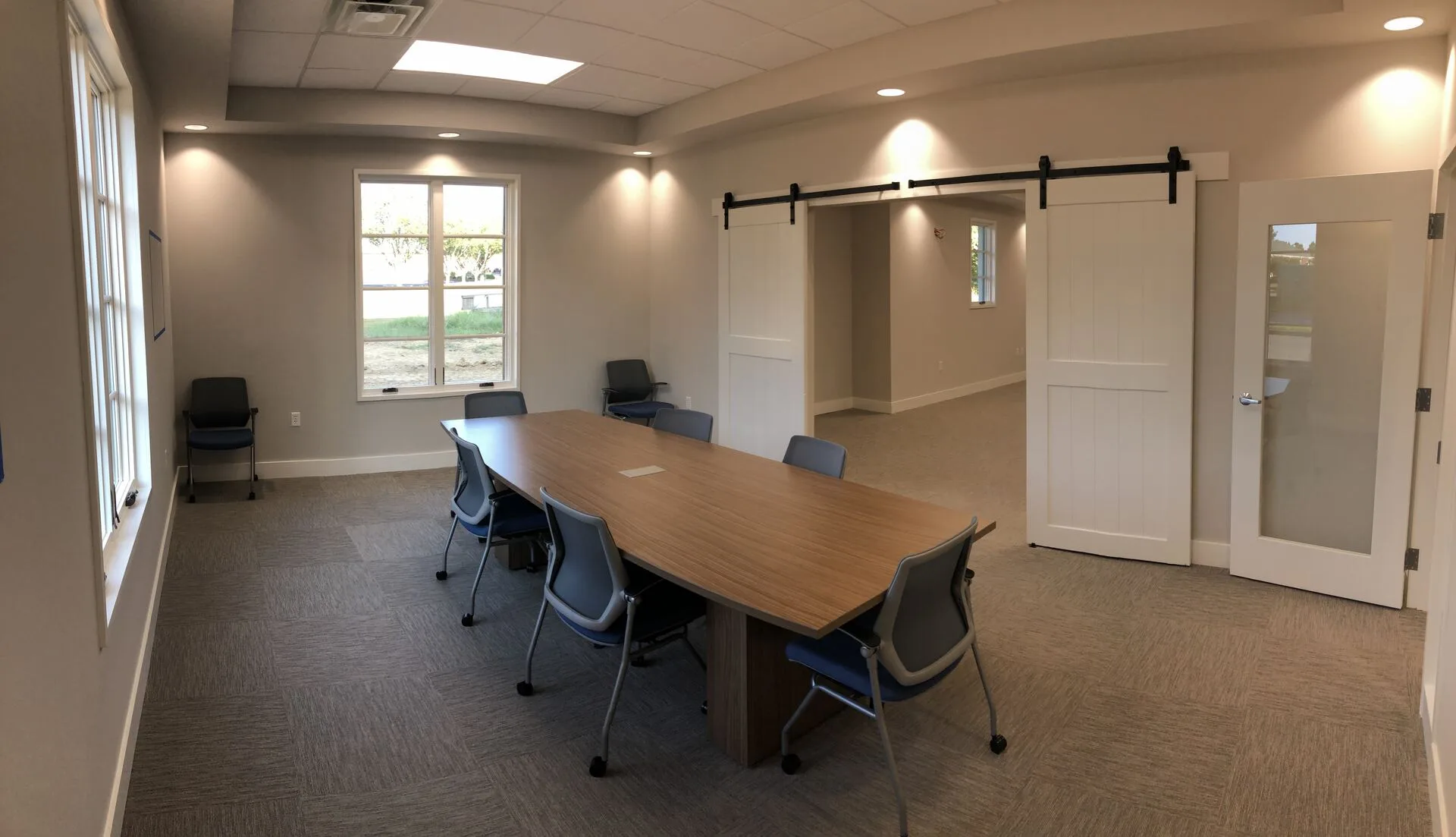 Small conference room with barn-door entry to open space