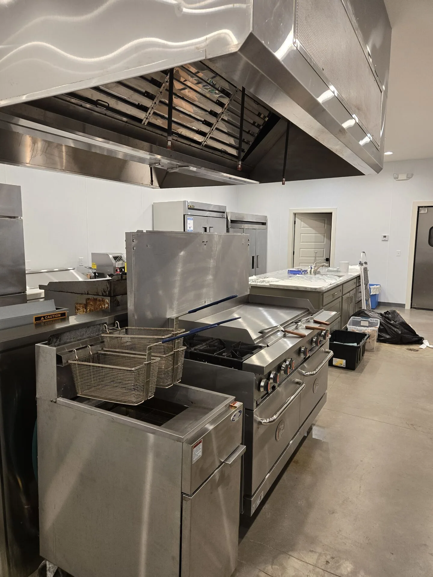 Commercial kitchen prep station with stainless work surface
