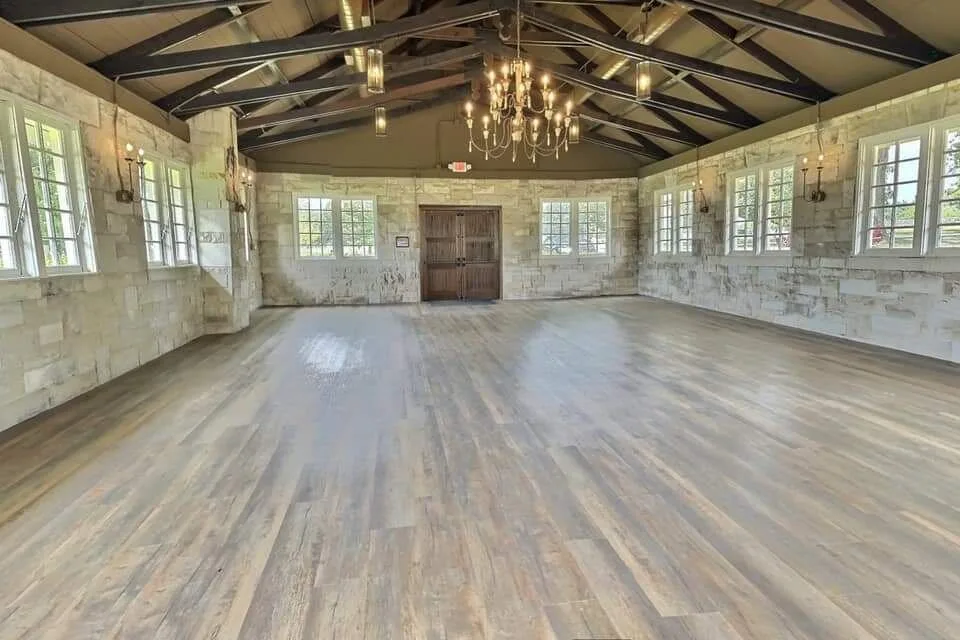 Magnolia Manor and Chapel event hall interior — exposed wooden trusses and chandeliers, restored by PCS Builder